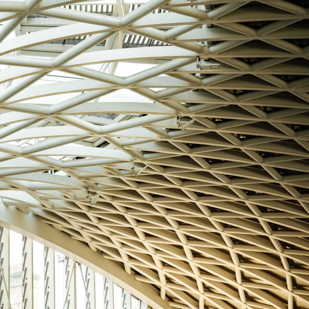 Intricate lattice-style architectural ceiling design in London's King's Cross station.